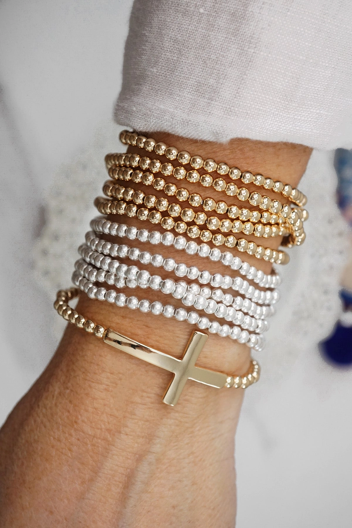 Entire Fusions Magical Perspective Minimal Cross Stretchy Bracelet in Gold tone with Ball Beads