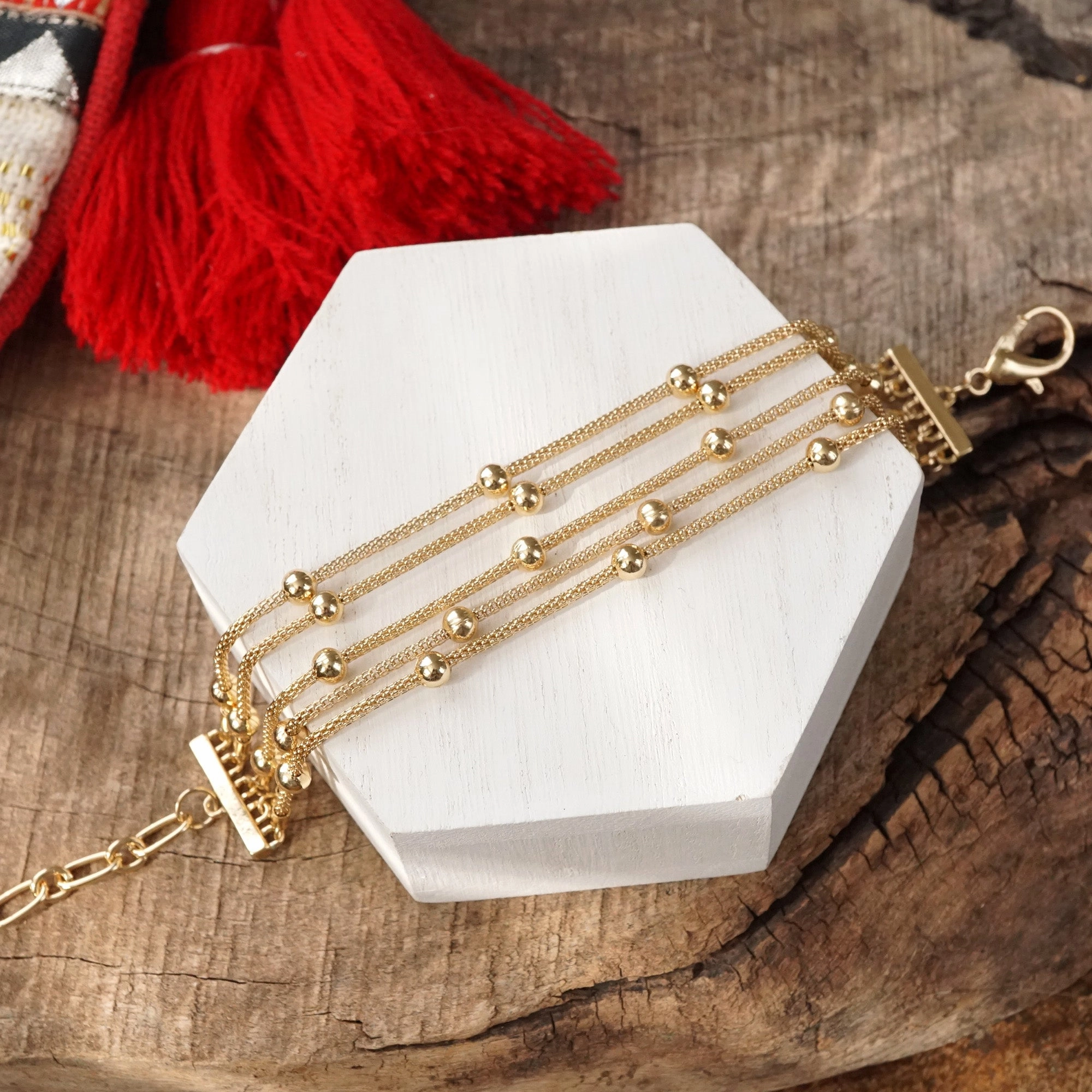 Significant Contribution Multi Chain Bracelet with ball beads in gold tone